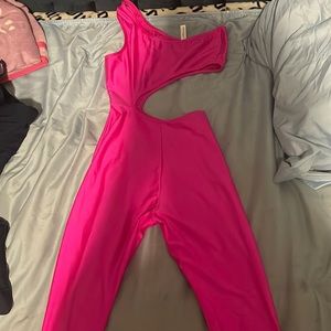 Pink one side jumpsuit cut out around stomach flare out at the ankles